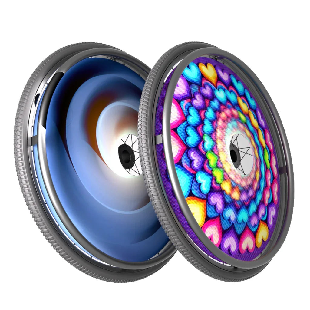 Two wheelchair wheels with colorful spoke guard designs, one abstract, one with heart pattern