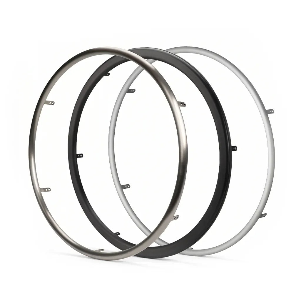 Three wheelchair handrims in black, silver, and titanium finish on white background