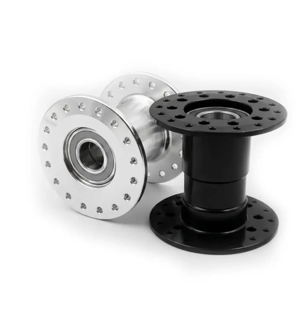 Durable wheelchair wheel hubs in black and silver, featuring precision bearings and mounting holes for secure attachment.