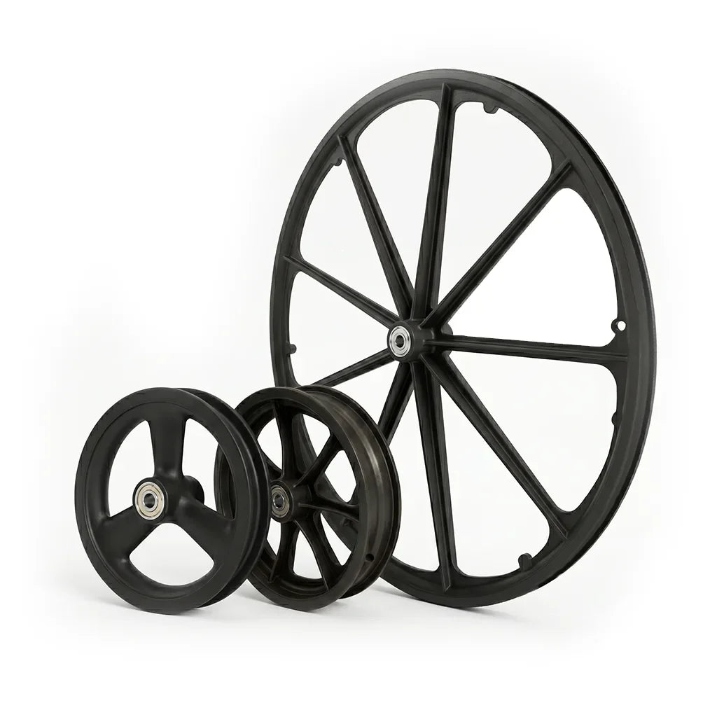 Various sizes of black wheelchair rims and wheels on white background