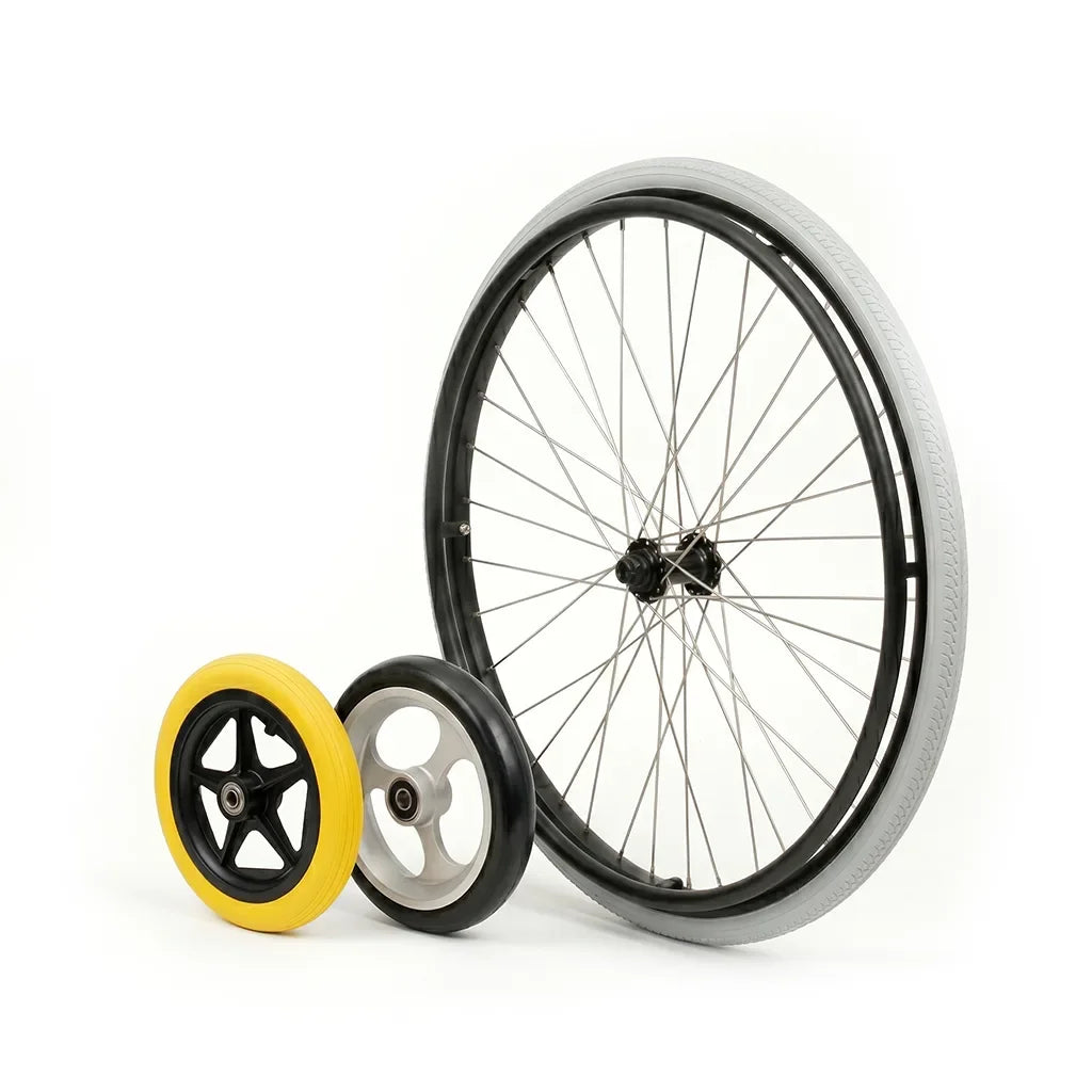 Three wheelchair wheels of different sizes and colors on a white background