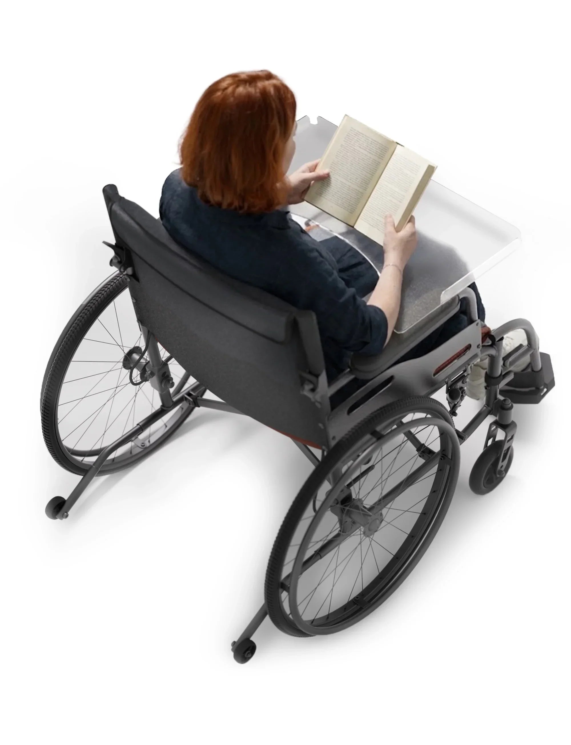 Woman reading a book on a wheelchair featuring transparent spoke guards and tray