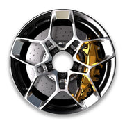 Close-up of a car wheel spoke guard with metallic and gold detailing on a white background.