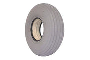 Durable wheelchair tire with ribbed tread and sturdy rim for reliable mobility support