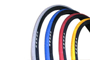 Colorful Kenda wheelchair tires in white, blue, red, and yellow for durable mobility solutions