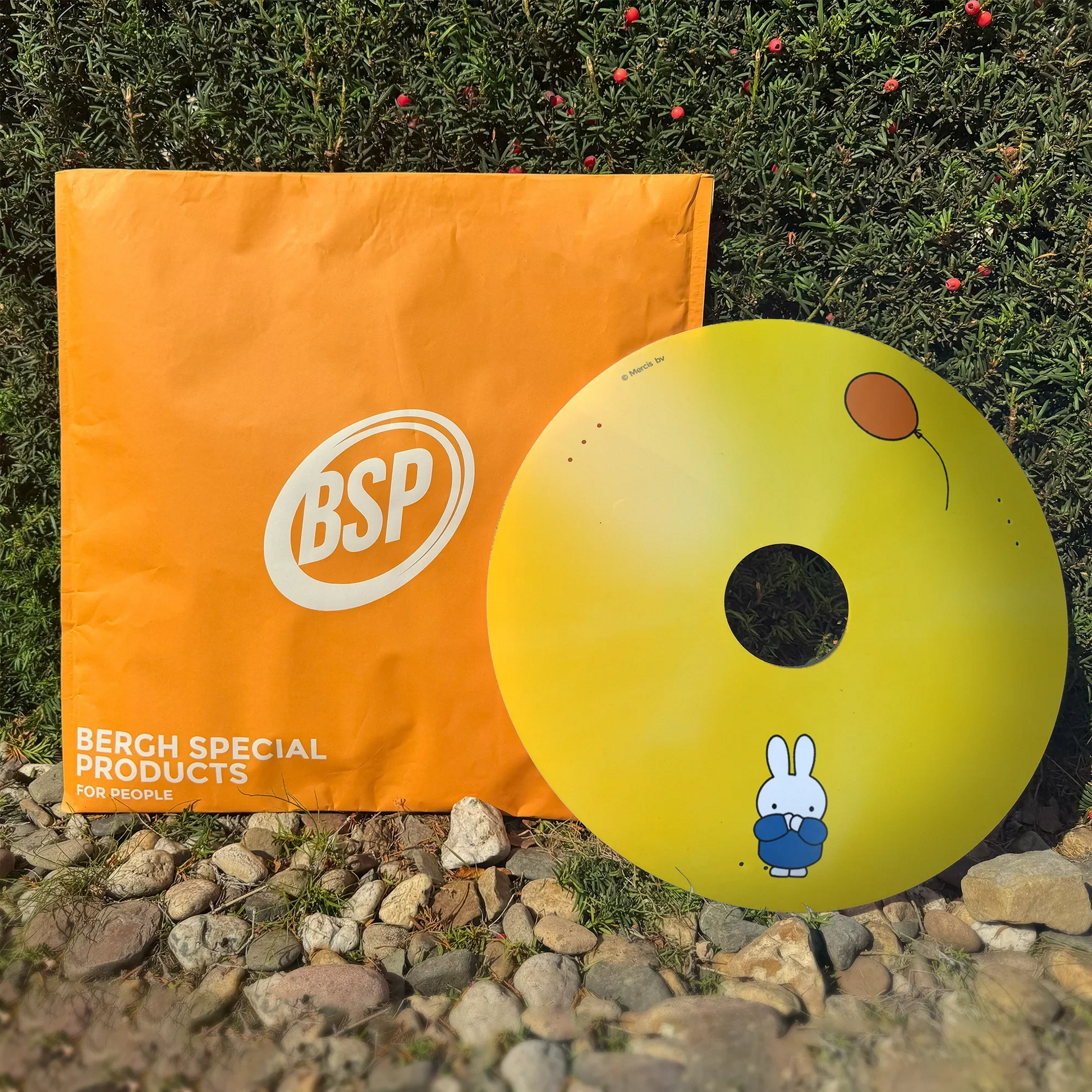 Miffy wheelchair spoke guard with yellow background and balloon, displayed outdoors.