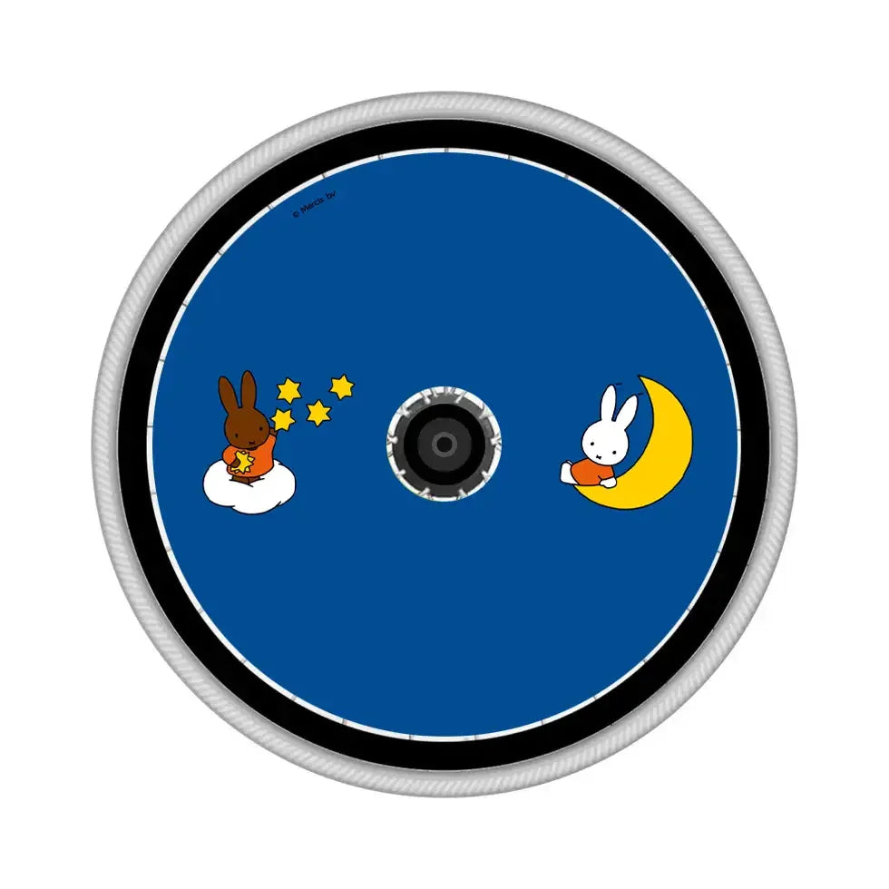 Blue wheelchair spoke guard featuring cartoon bunnies, yellow stars, and crescent moon design.