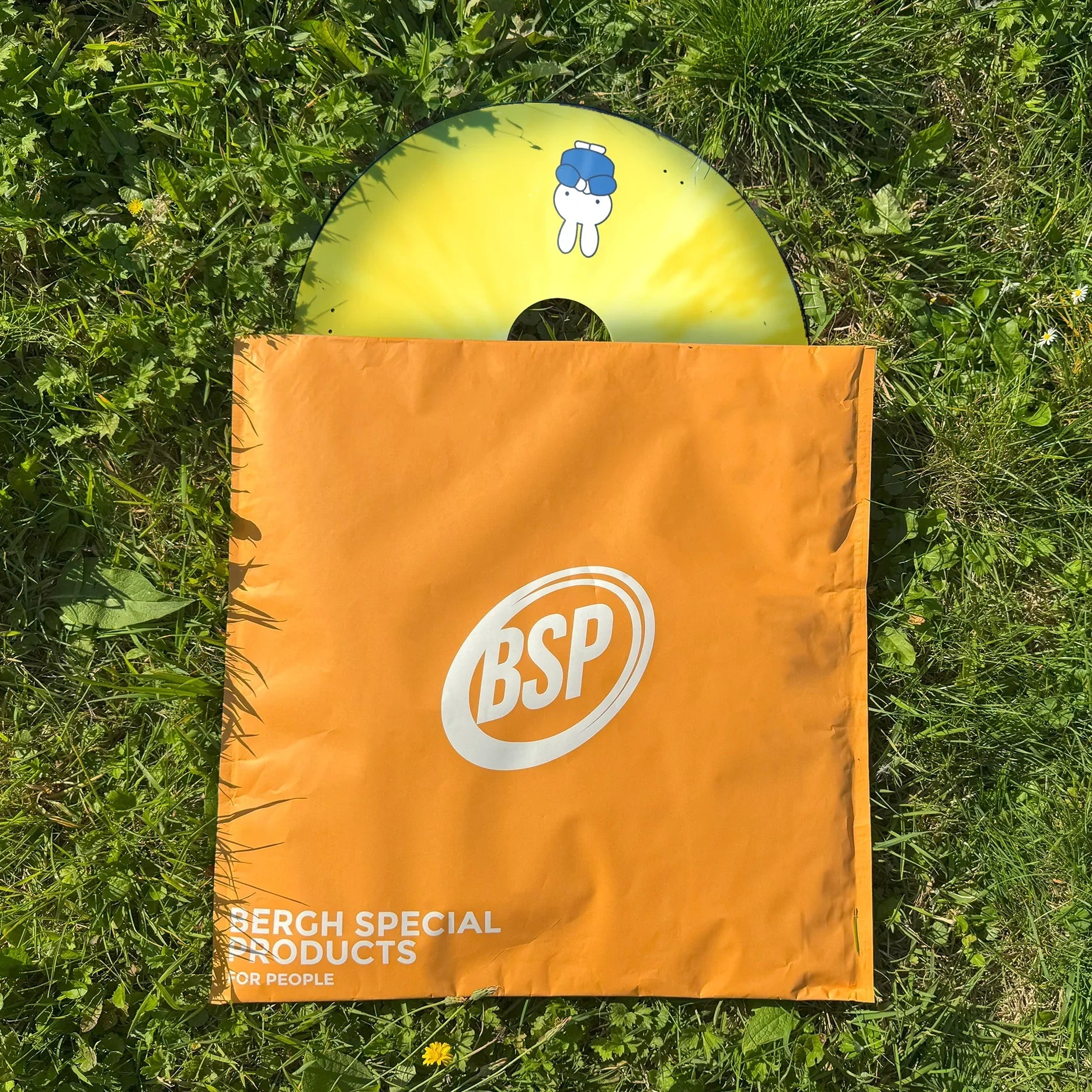 Miffy cartoon wheelchair spoke guard with yellow background in orange BSP bag on grass