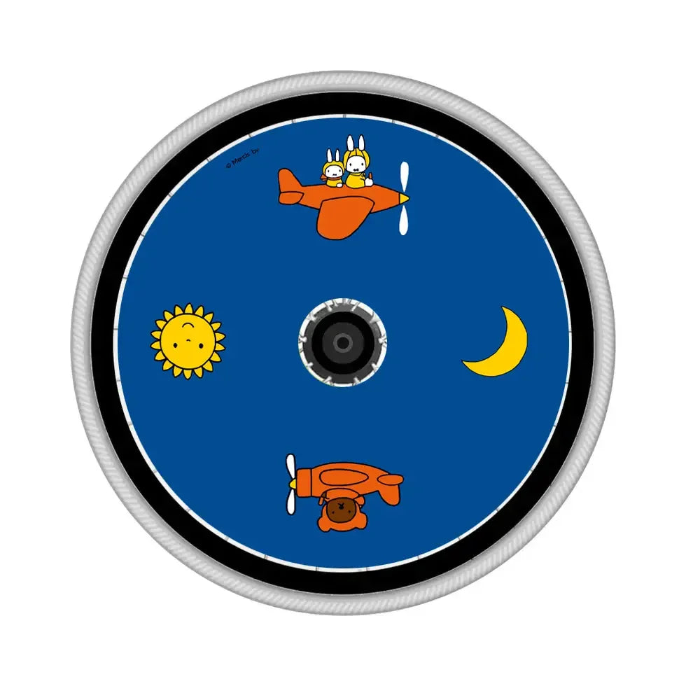 Colorful wheelchair spoke guard with cartoon bunny in airplane, sun, moon, and bear design.