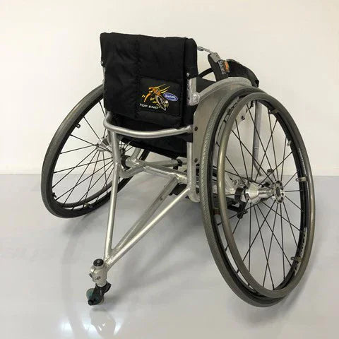 Lightweight manual wheelchair with black padded backrest, silver frame, and large spoked wheels for mobility support.