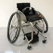 Lightweight manual wheelchair with black seat, footrest, and orange accents, ideal for mobility and daily use.