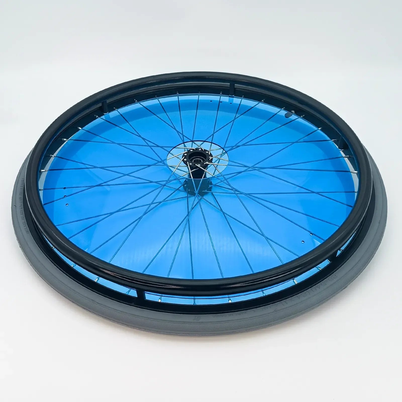 Blue wheelchair wheel with black rim and spokes, durable mobility accessory for everyday use
