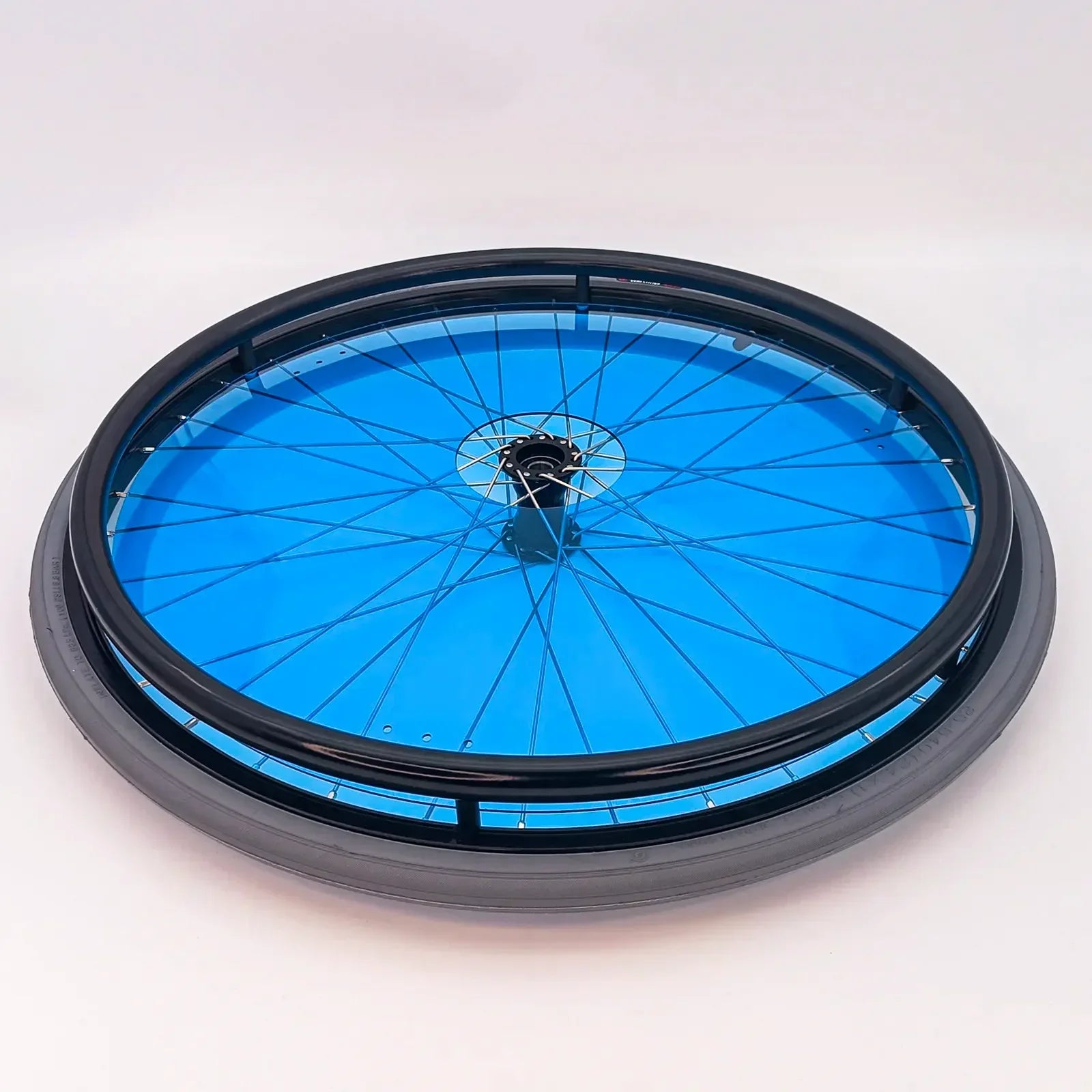 Blue wheelchair wheel with black rim and spokes, durable mobility accessory for everyday use