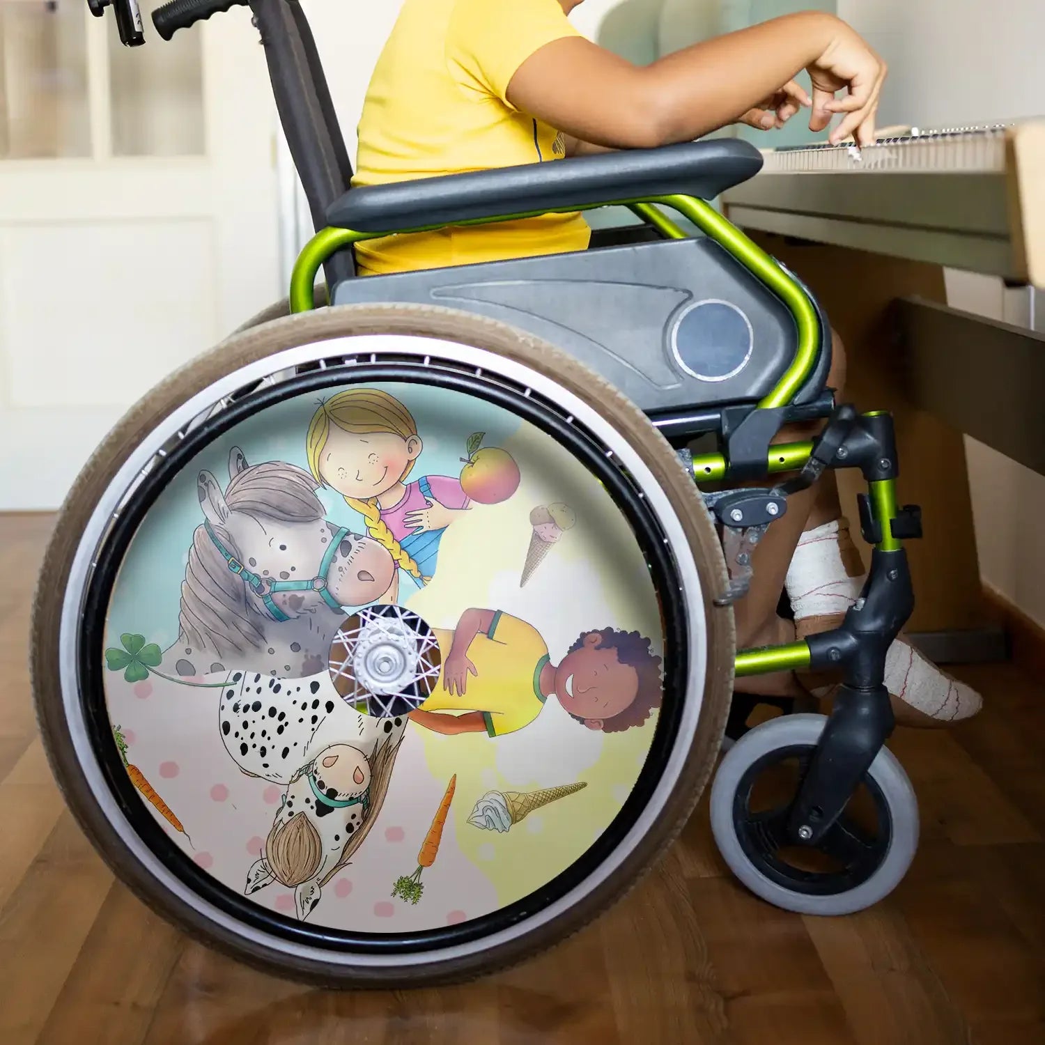 Child in wheelchair with colorful spoke guard featuring cartoon animals and children