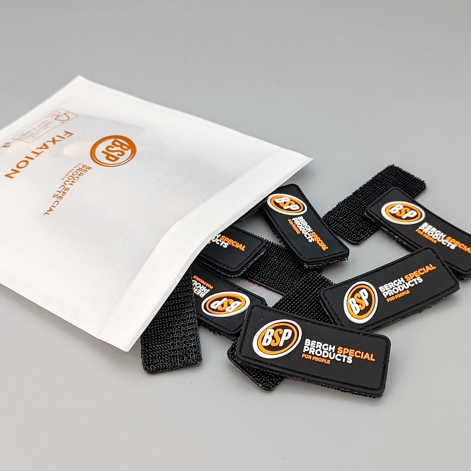 Black wheelchair fixation straps with Bergh Special Products logo, packaged for accessibility equipment use