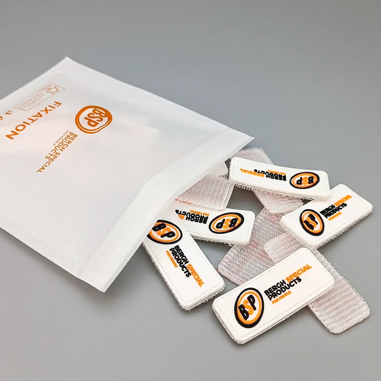 White Velcro fixation straps with Bergh Special Products logo for wheelchair accessories