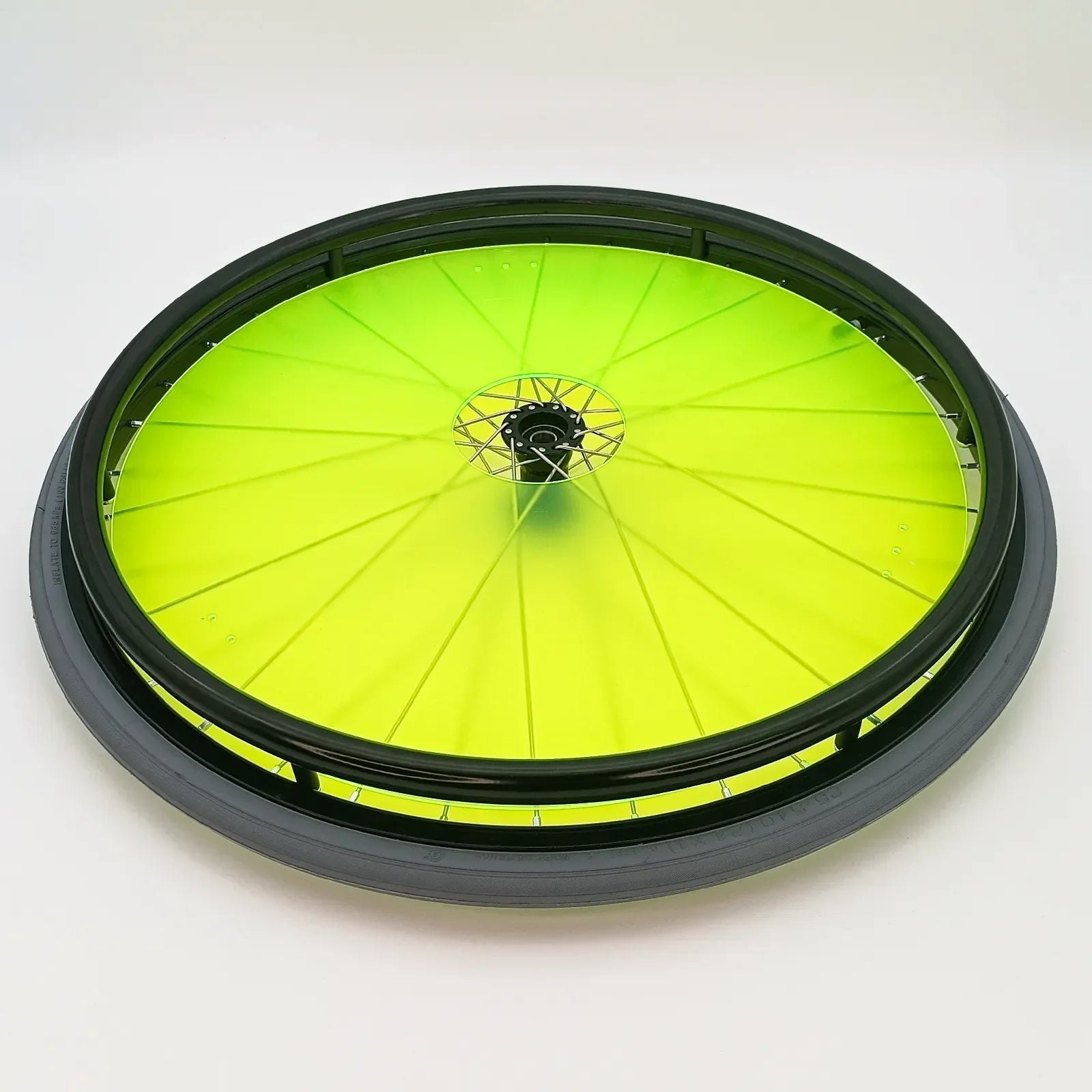 Bright lime green wheelchair spoke guard with black rim, durable accessory for wheelchair wheels