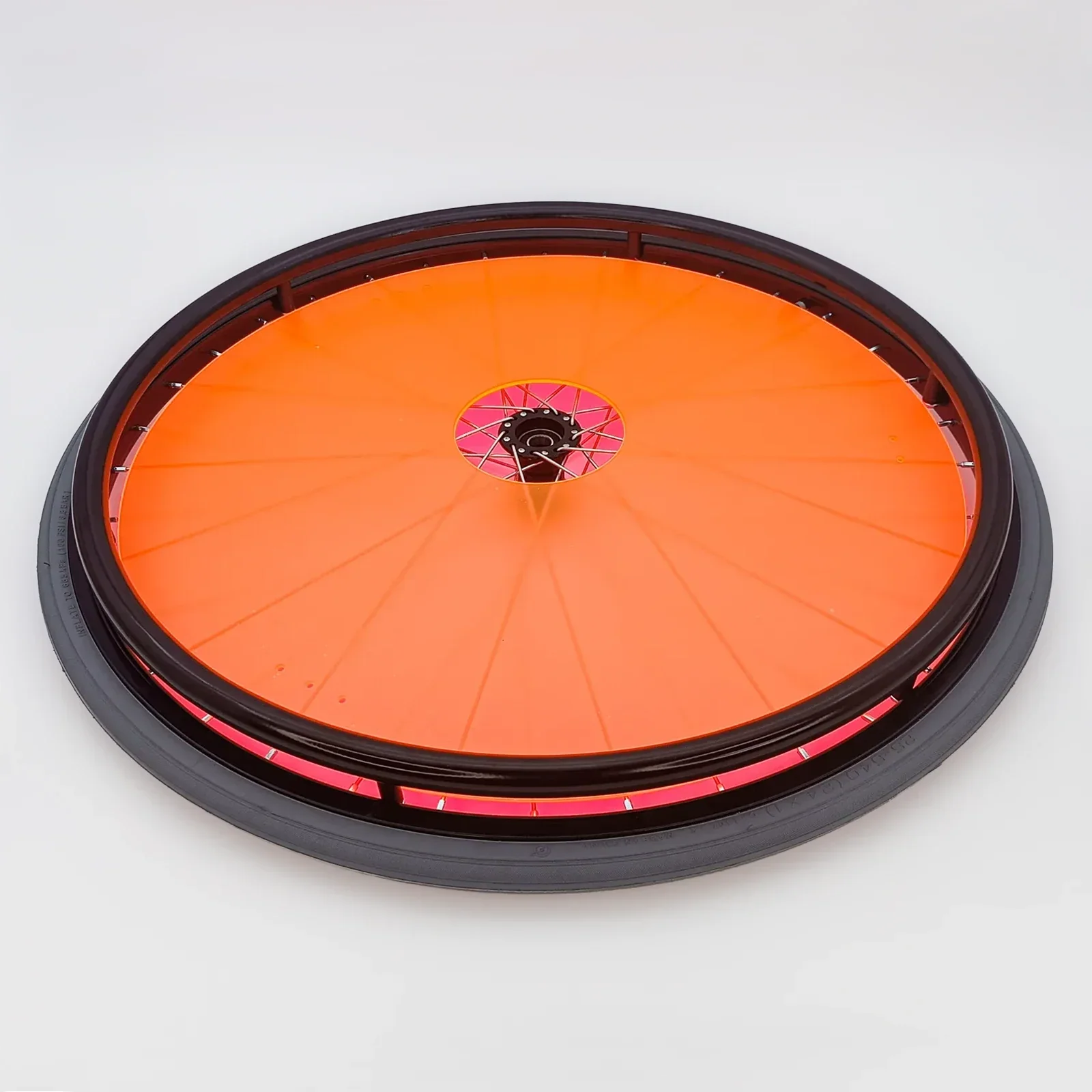 Bright orange wheelchair spoke guard with black rim and pink accents for safety and style