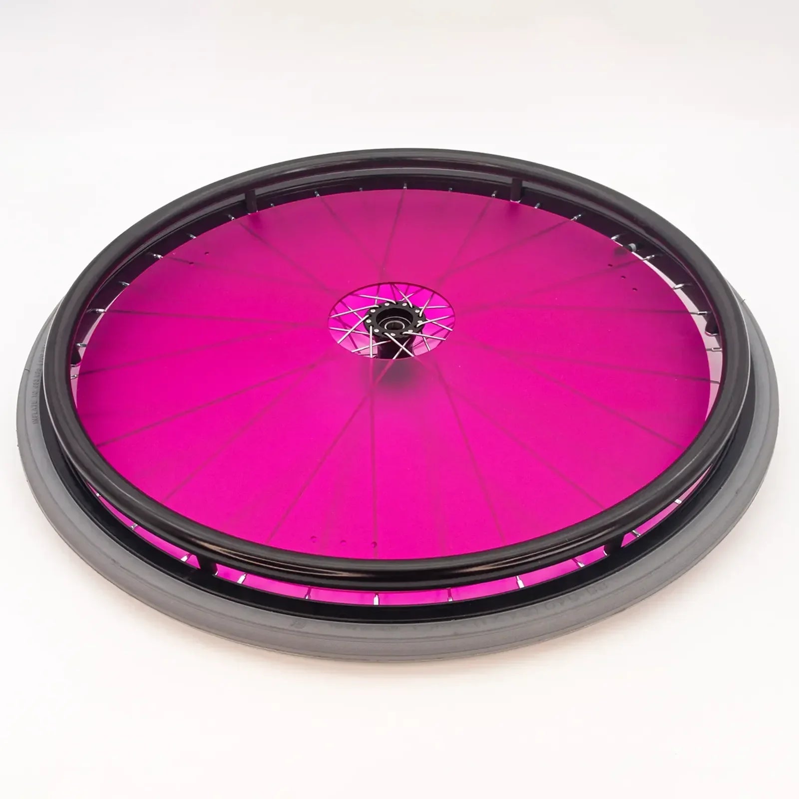 Vibrant pink wheelchair wheel with black rim and spokes, durable accessory for mobility devices