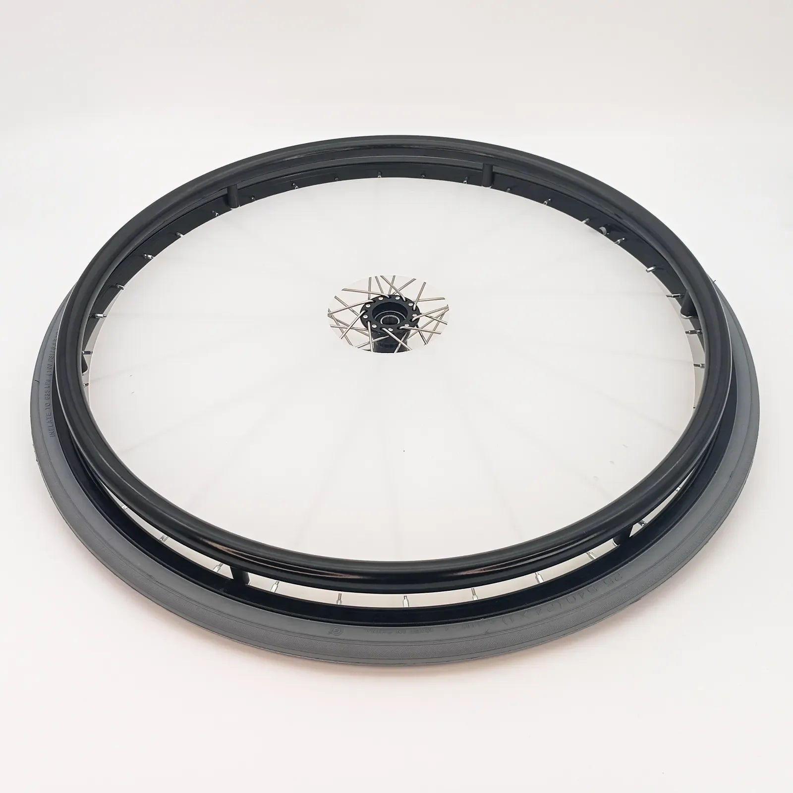 Black wheelchair wheel with spoke guard and tire, durable mobility accessory for everyday use