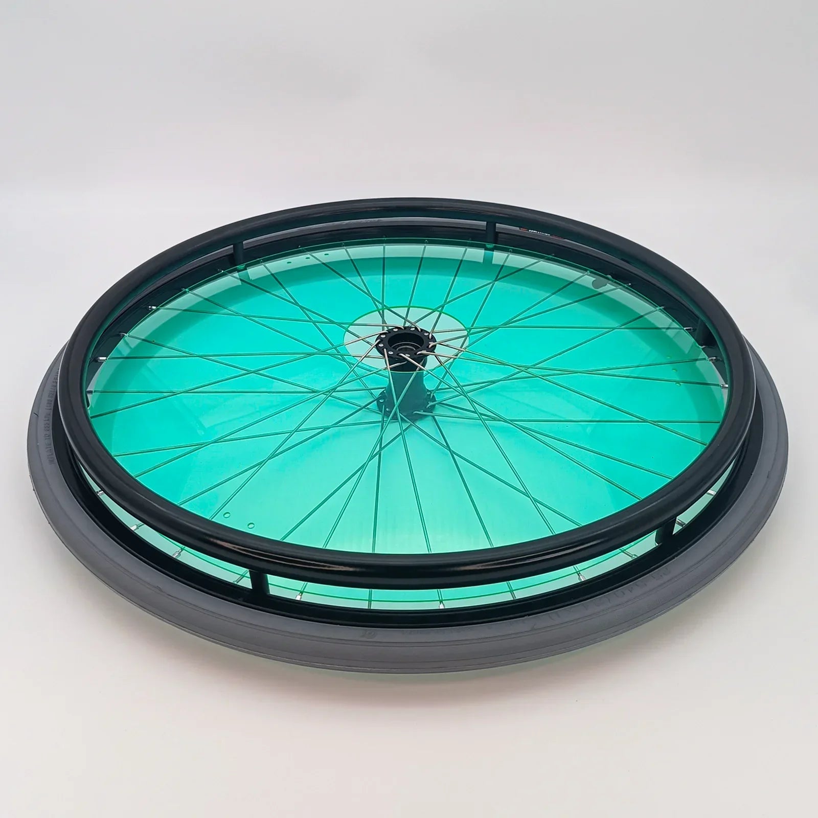 Teal wheelchair spoke guard with black rim, durable wheelchair accessory for safety and style