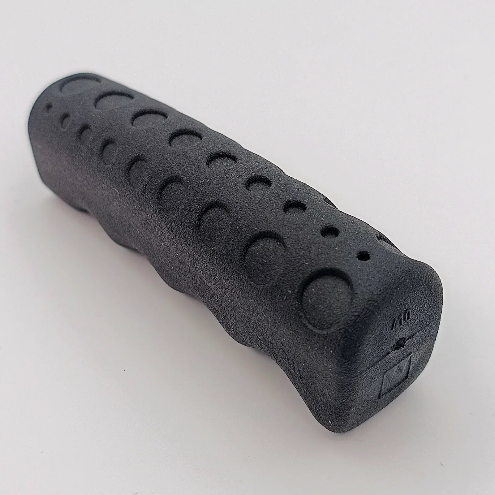 Black textured wheelchair hand grip with ergonomic design for secure handling and comfort