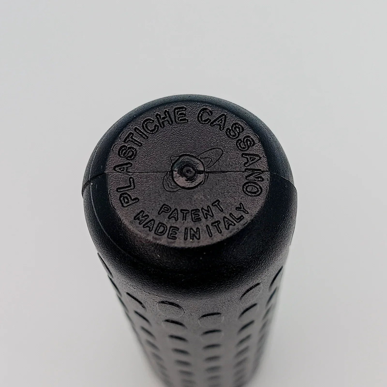 Black textured wheelchair grip with 'Plastiche Cassano' and 'Made in Italy' embossed, durable mobility accessory