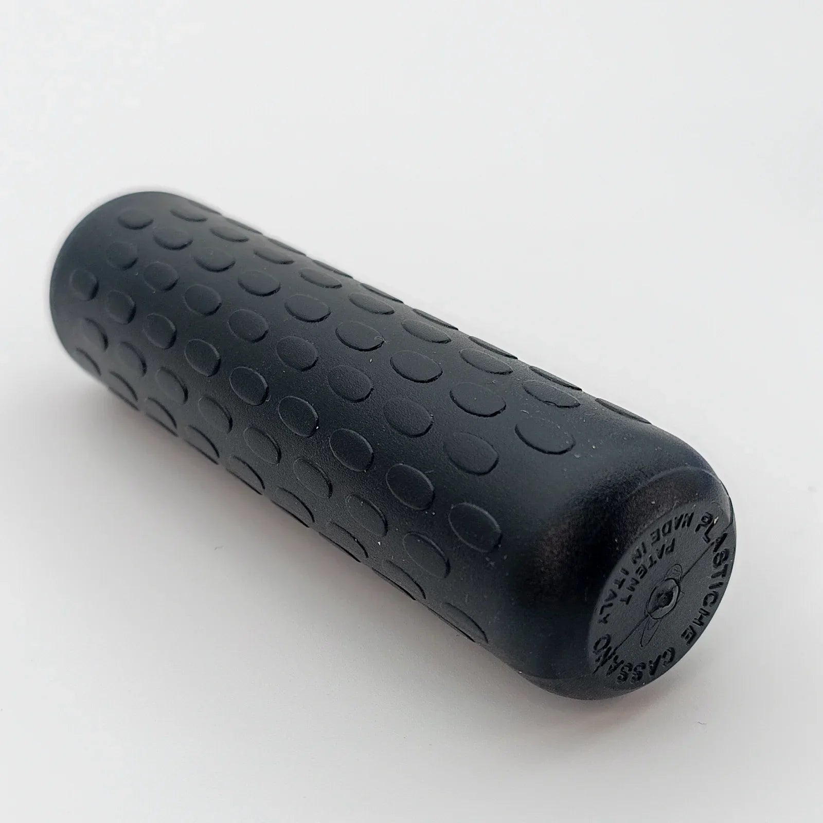 Black textured wheelchair hand grip with ergonomic dot pattern for secure push rim control