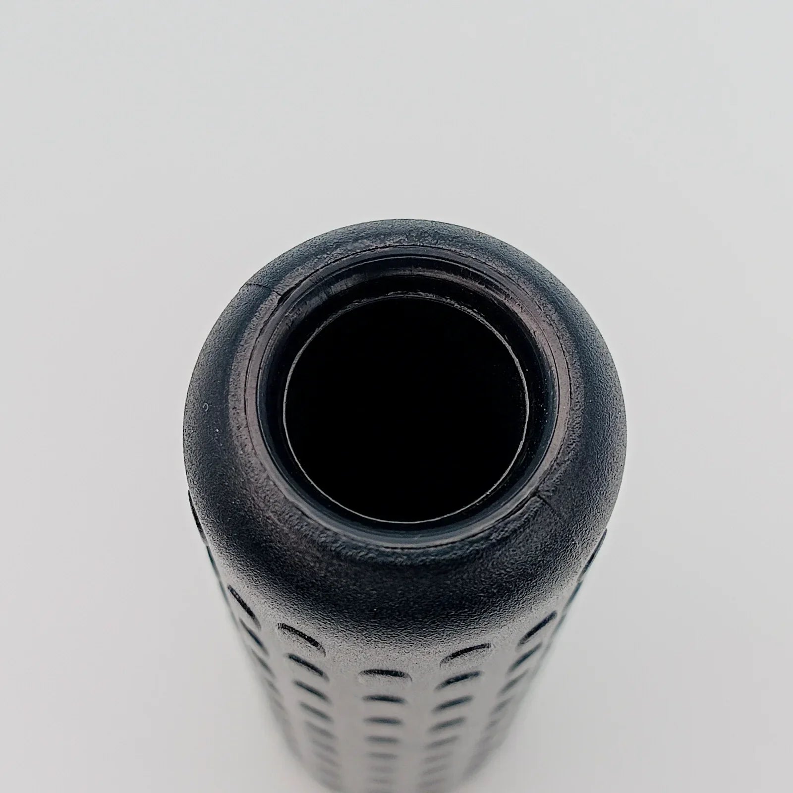 Black textured wheelchair grip with ergonomic design for secure handling
