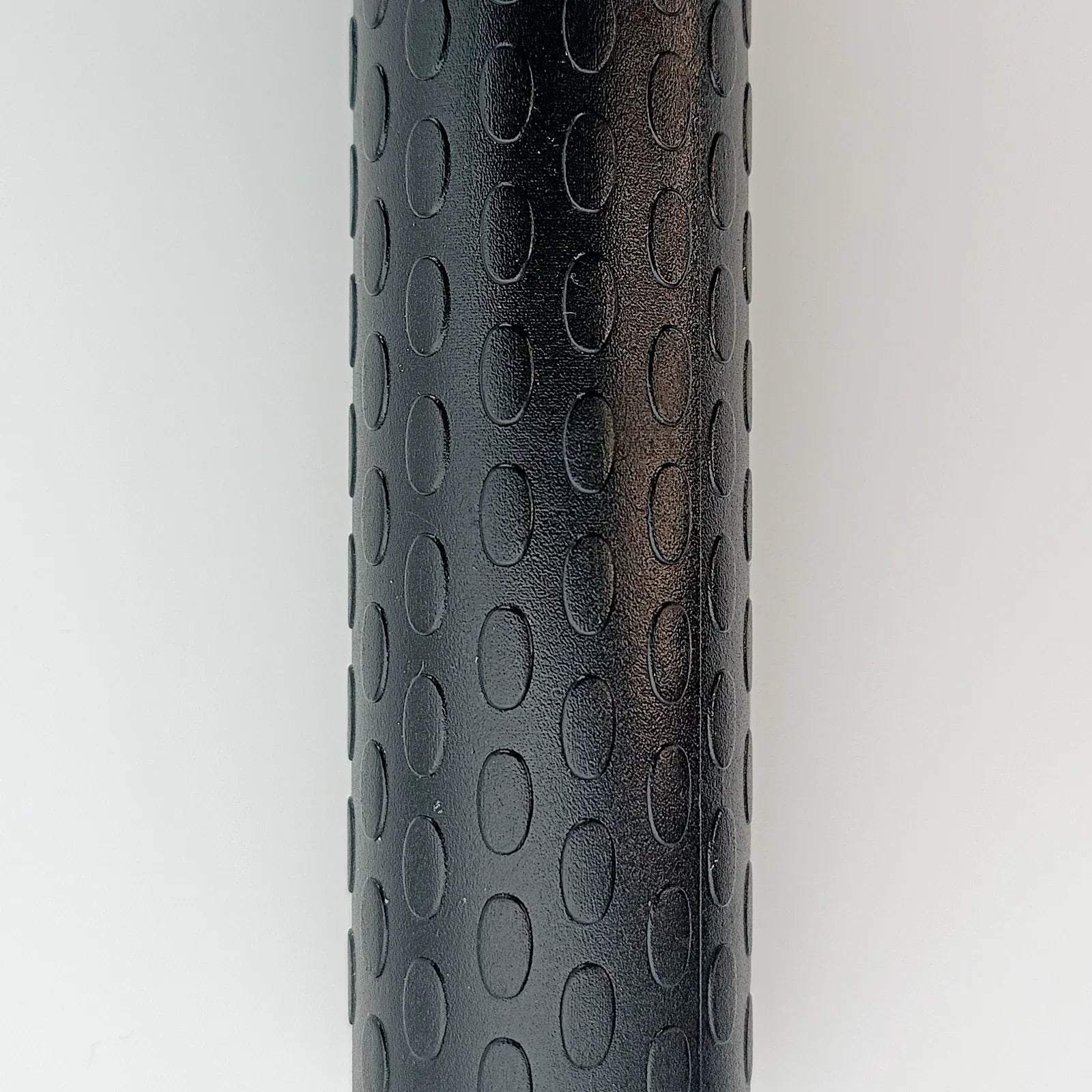 Black textured wheelchair handrim with oval grip pattern for secure handling