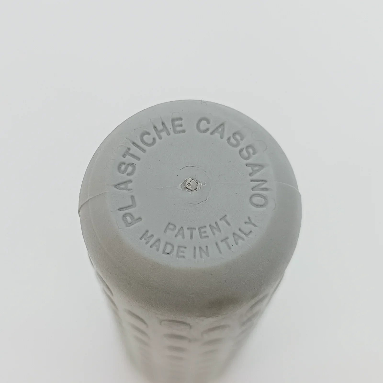 Gray wheelchair grip with 'Plastiche Cassano Patent Made in Italy' embossed, durable textured surface