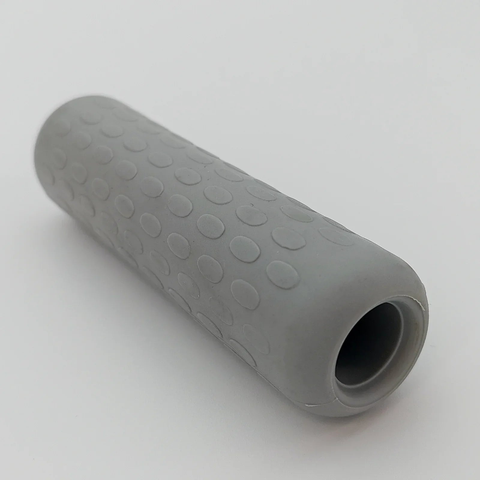 Gray textured wheelchair grip with non-slip dots for secure handling and comfort