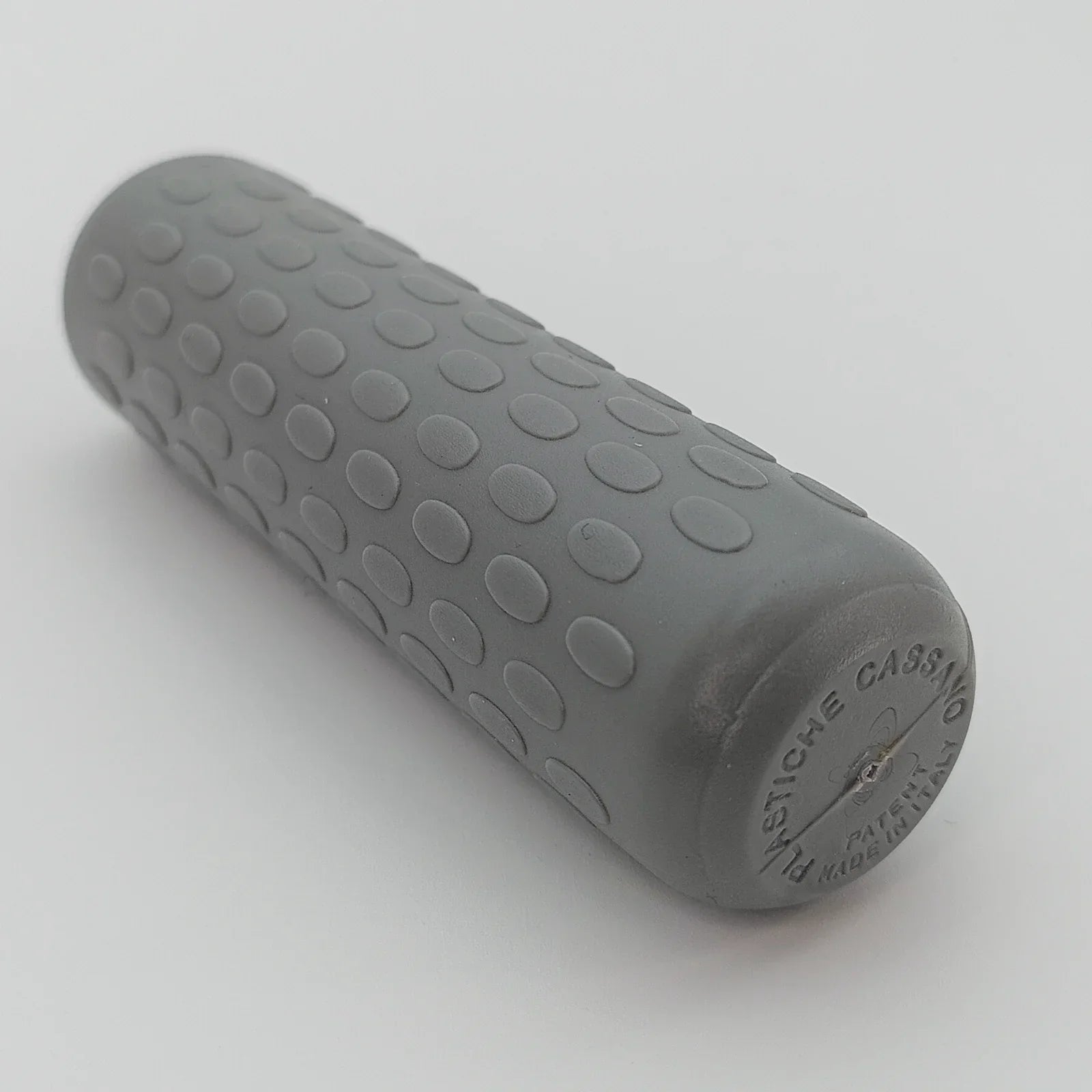 Gray textured wheelchair grip with dot pattern, made in Italy for secure handling