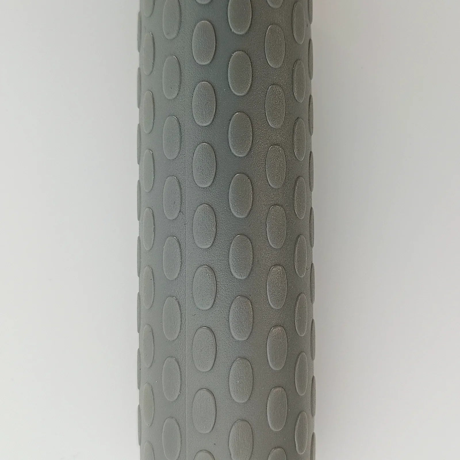 Gray textured wheelchair grip with oval patterns for secure handling