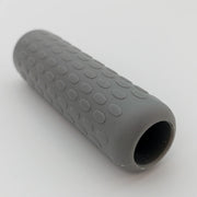 Gray textured wheelchair grip with oval patterns for secure handling and comfort