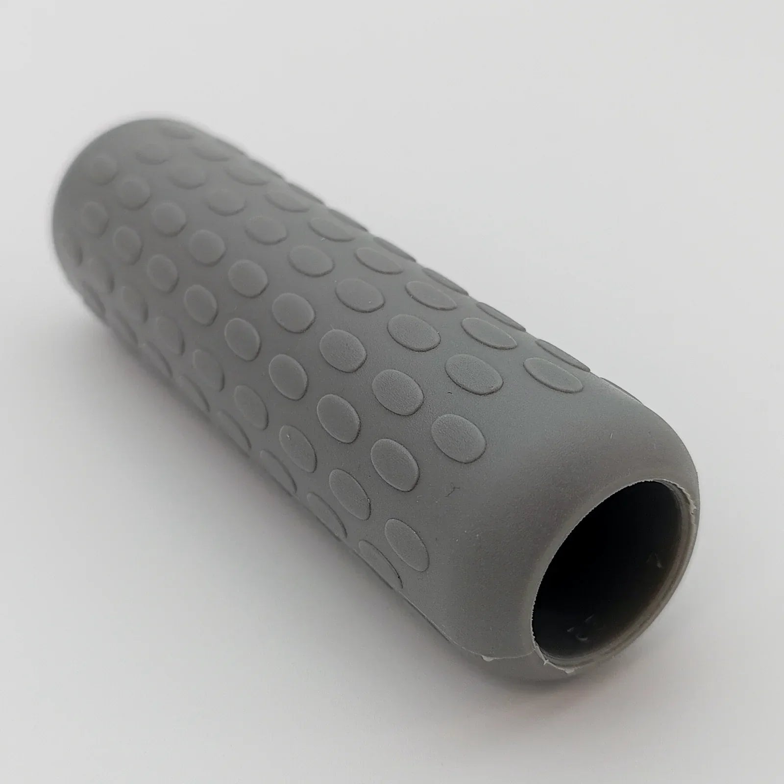 Gray textured wheelchair grip with oval patterns for secure handling and comfort