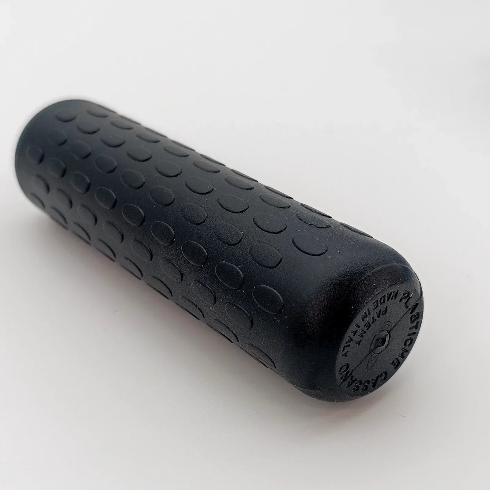 Black textured wheelchair handle grip with non-slip dots, durable for daily use