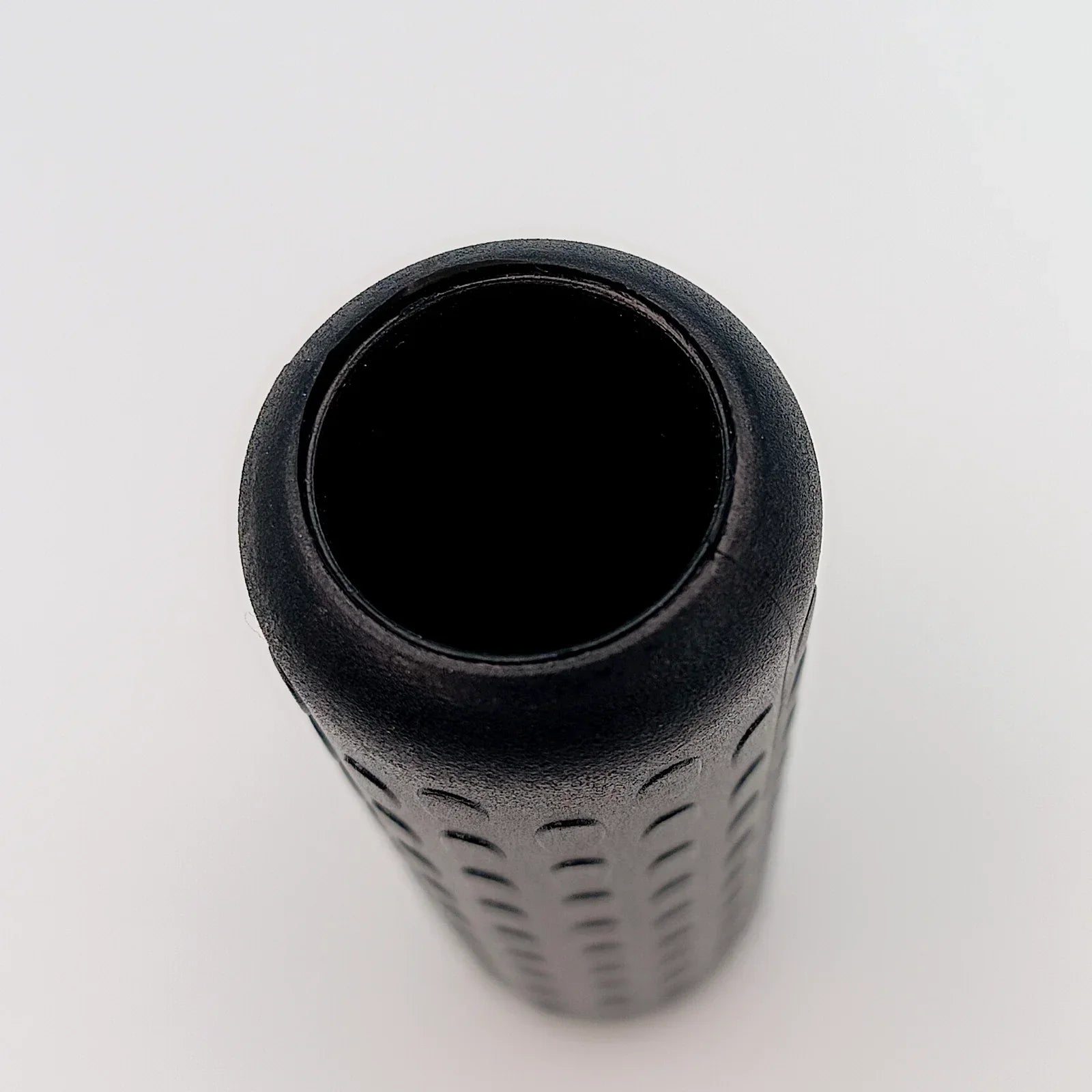 Black textured wheelchair grip with ergonomic pattern for secure handling and comfort