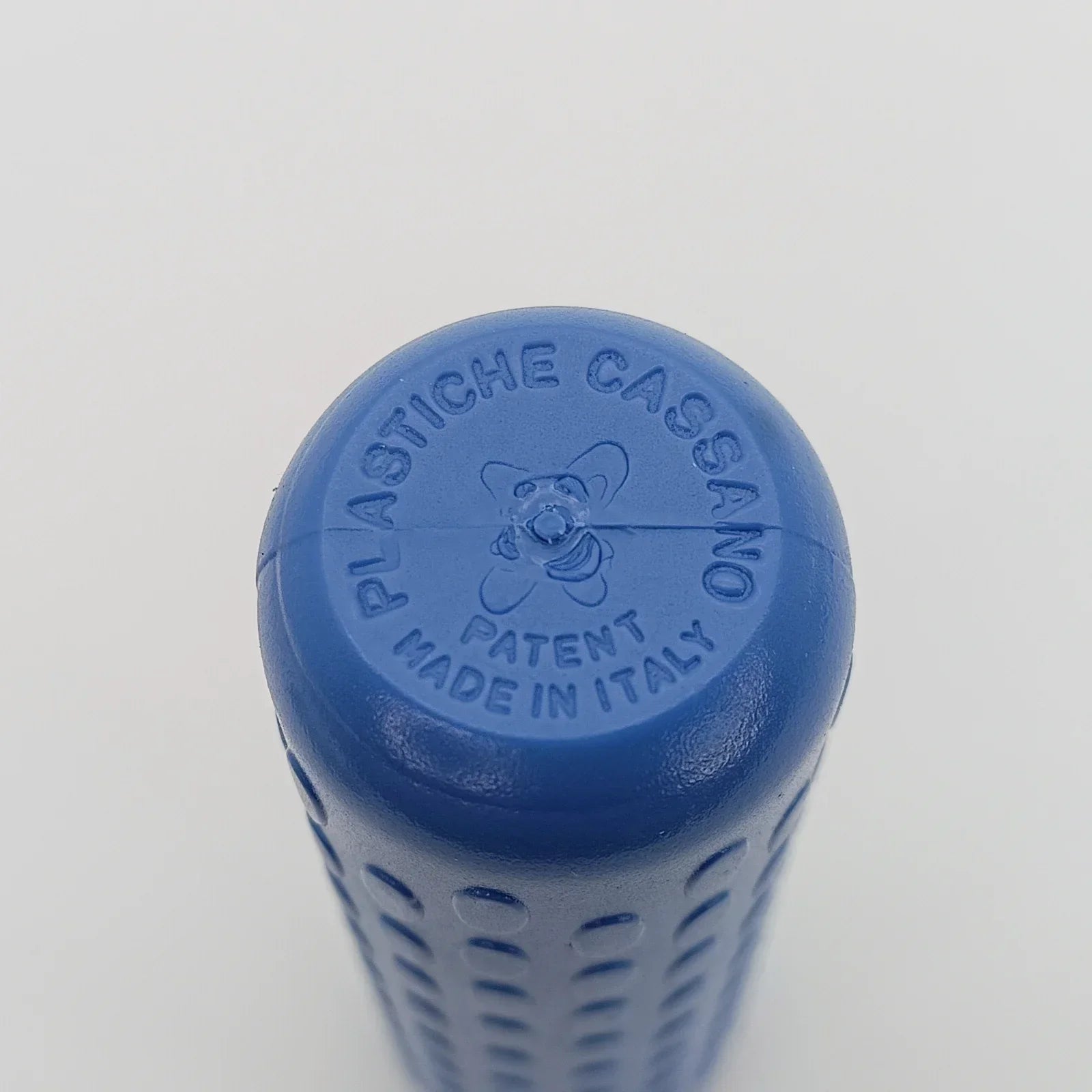 Blue wheelchair grip with textured surface, made in Italy, featuring embossed brand and patent details