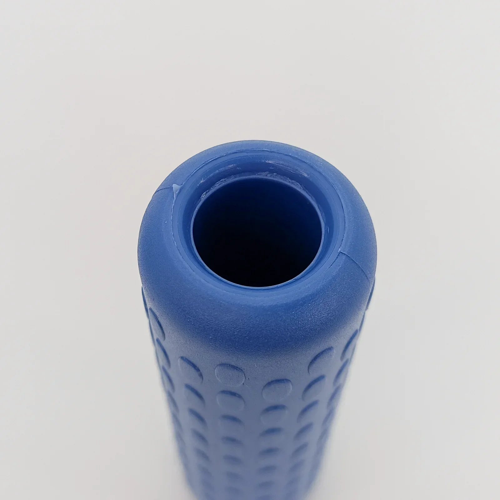 Blue textured wheelchair grip with ergonomic design for secure handling