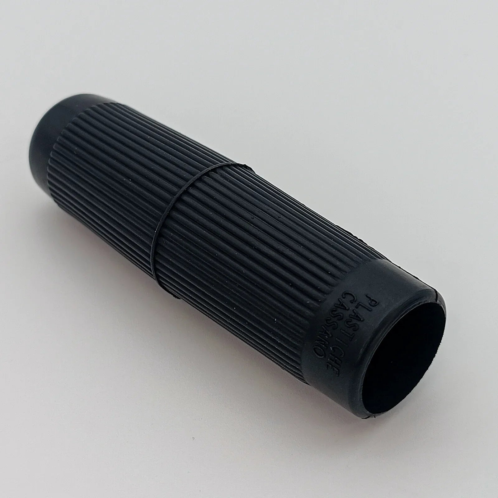 Black ribbed wheelchair hand grip with textured surface for secure hold, durable plastic design