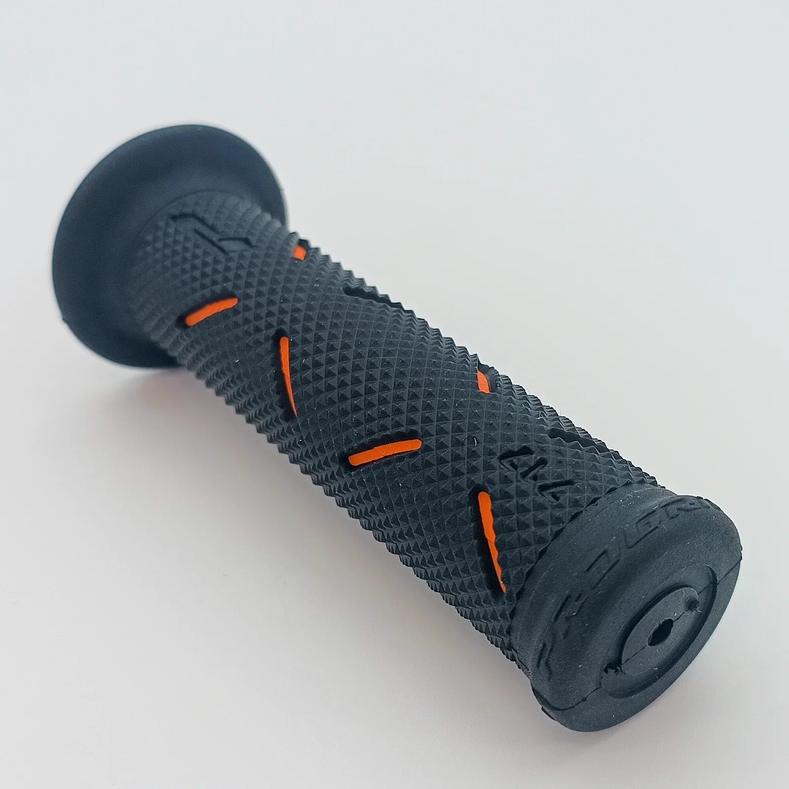 Black textured wheelchair grip with orange accents for secure handling
