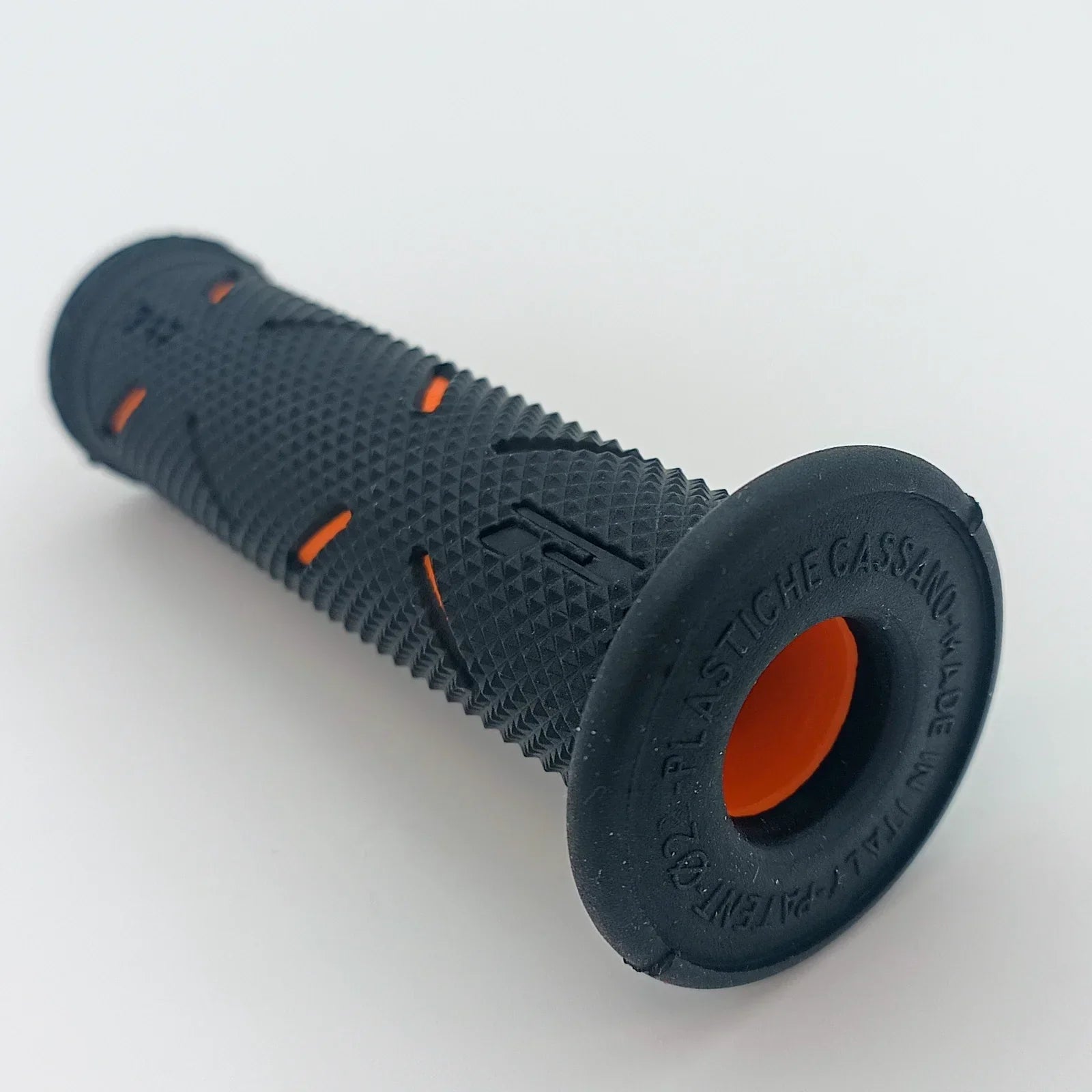 Black textured wheelchair grip with orange accents, durable ergonomic handle for mobility aids