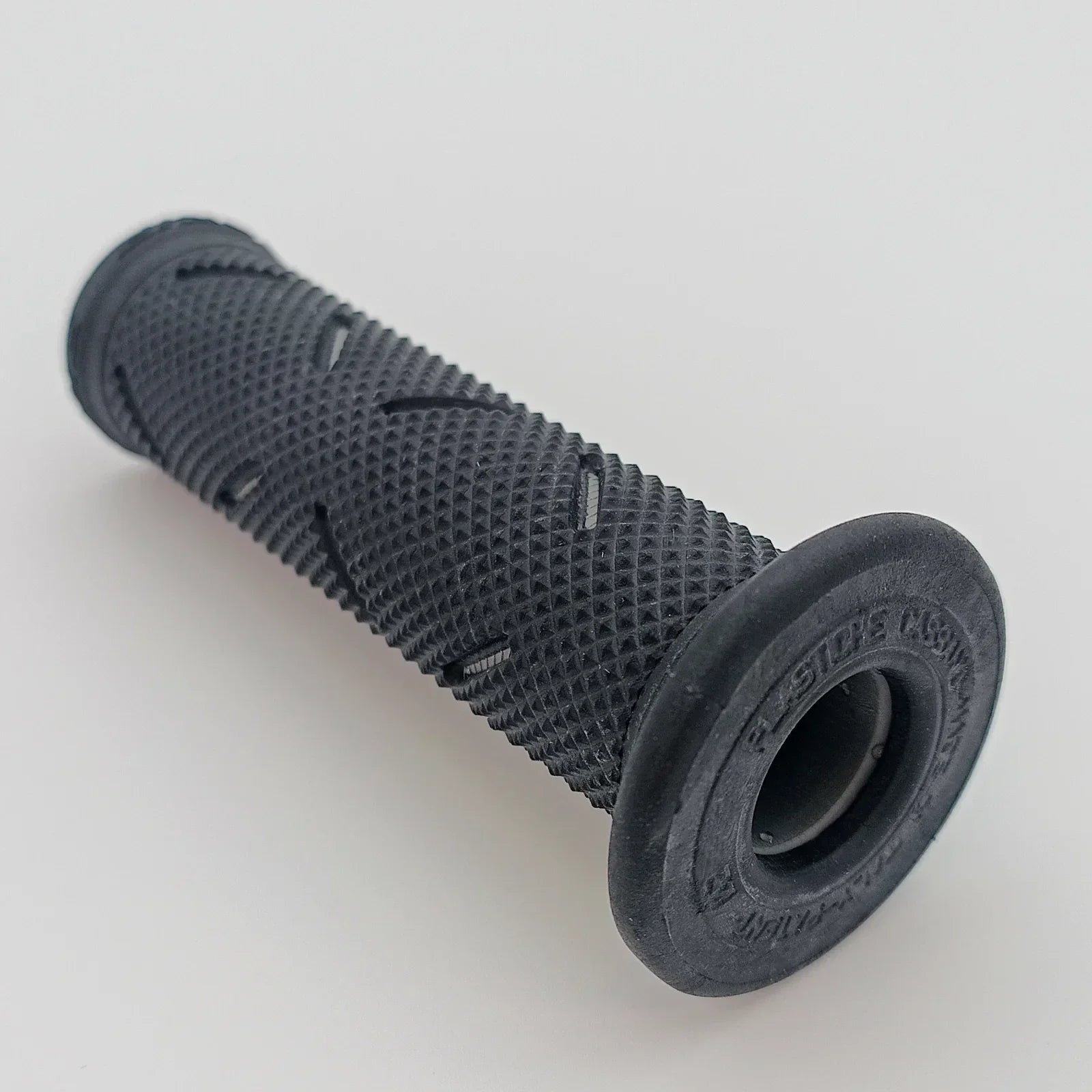 Black textured wheelchair grip with ergonomic design for secure handling and comfort