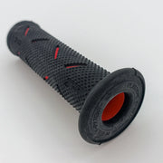 Black textured wheelchair grip with red accents, durable ergonomic handle for mobility aids