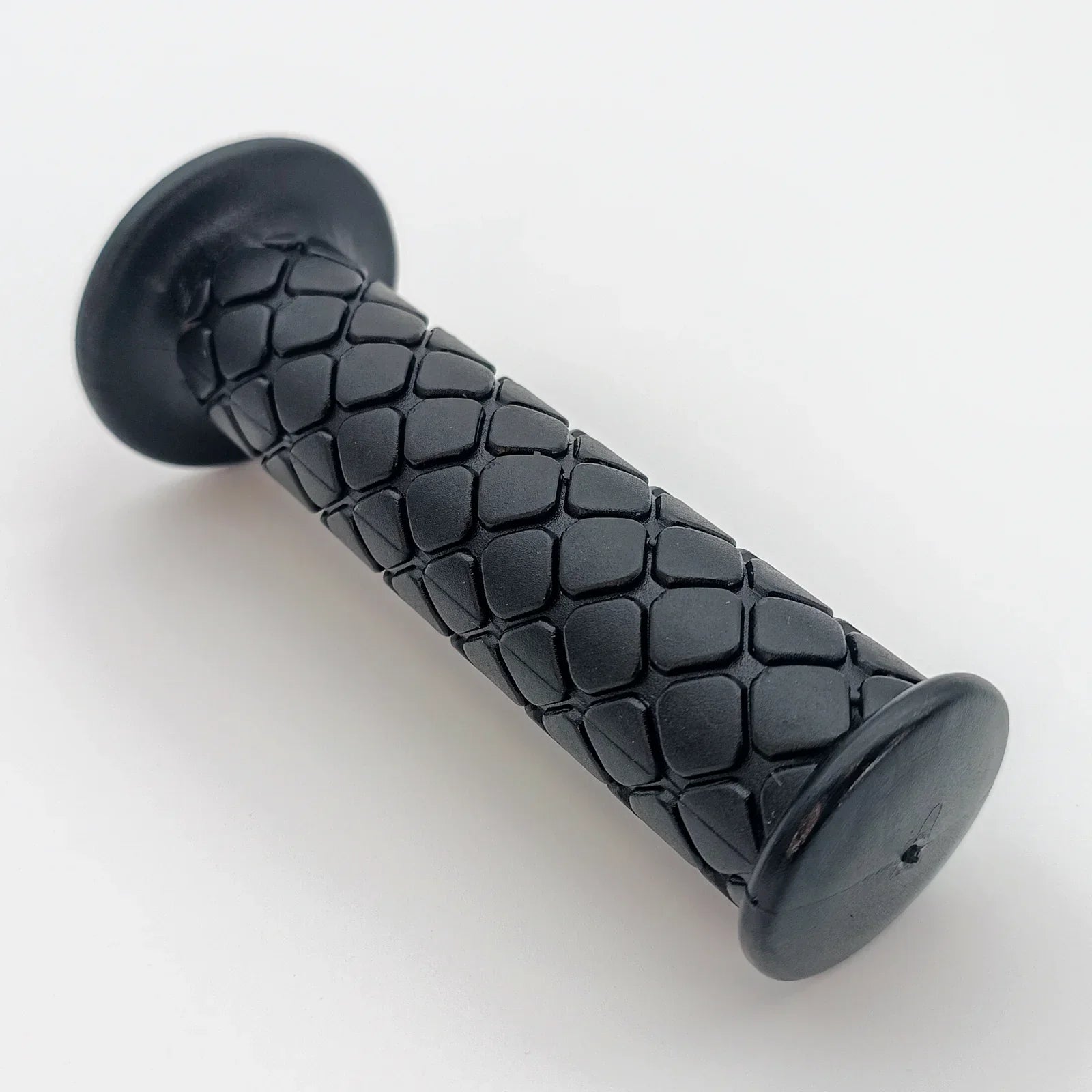Black textured wheelchair hand grip with ergonomic hexagonal pattern for secure handling