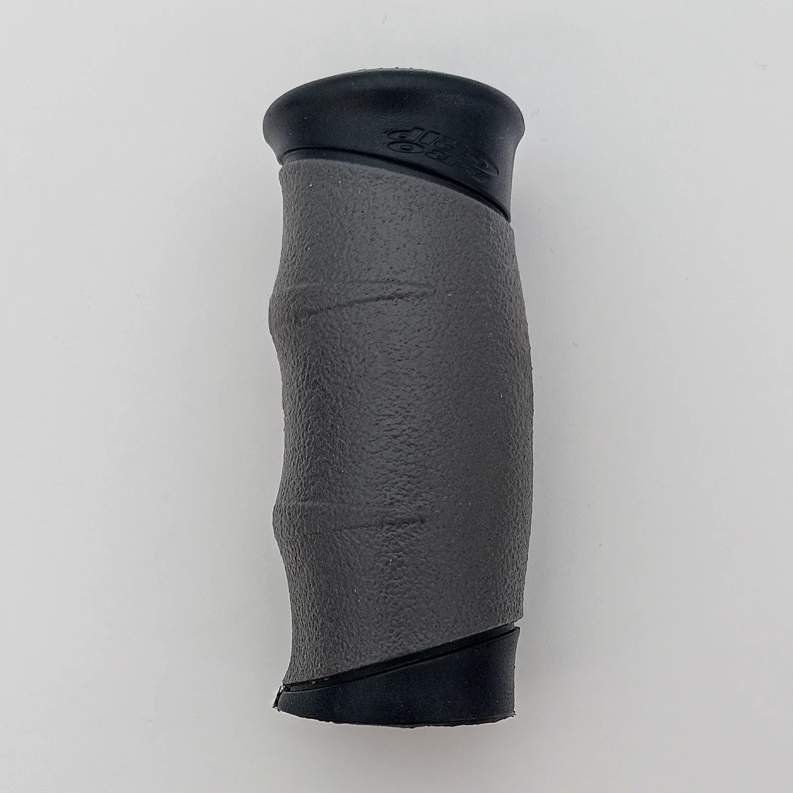 Black textured wheelchair hand grip with ergonomic design for secure hold and comfort
