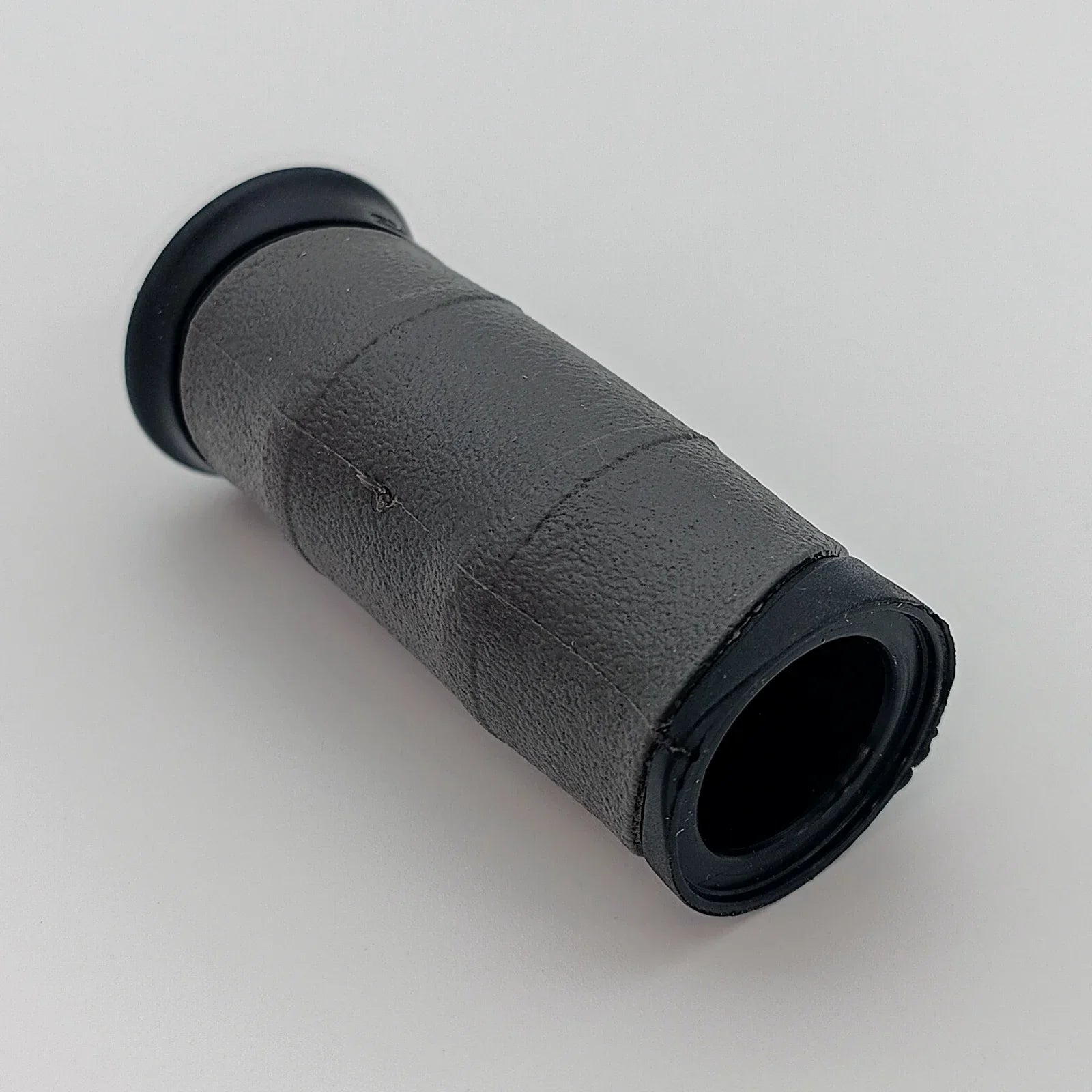 Black textured wheelchair handle grip with secure end caps for comfortable, durable use