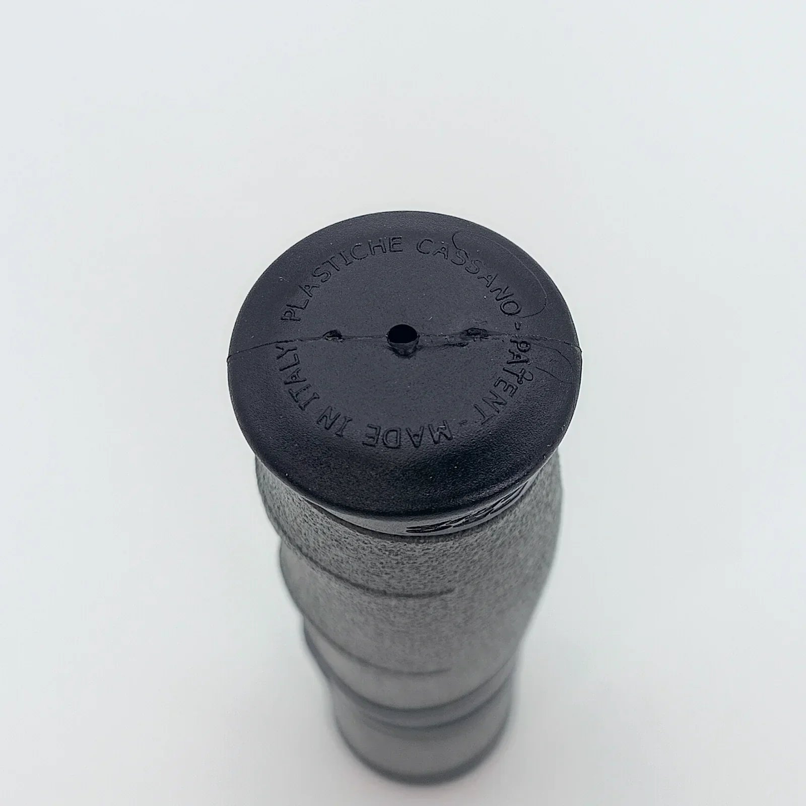 Black wheelchair handle grip with textured surface and 'Made in Italy' marking for secure mobility support