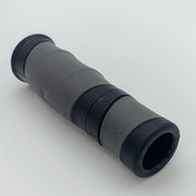 Gray and black textured wheelchair handle grip with ergonomic design for secure hold